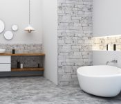 White tub with stone flooring
