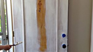 paintbrush painting natural wooden door