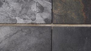 placing dark grey ceramic floor tiles